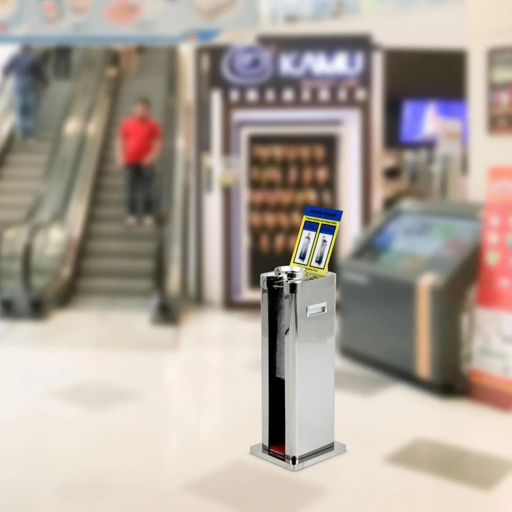 Automatic wet umbrella packaging machine, stainless steel single-slot umbrella bag distributor bracket, equipped with 1000 long umbrella bags and warning signs, suitable for commercial shopping centers, hotels, in silver color.