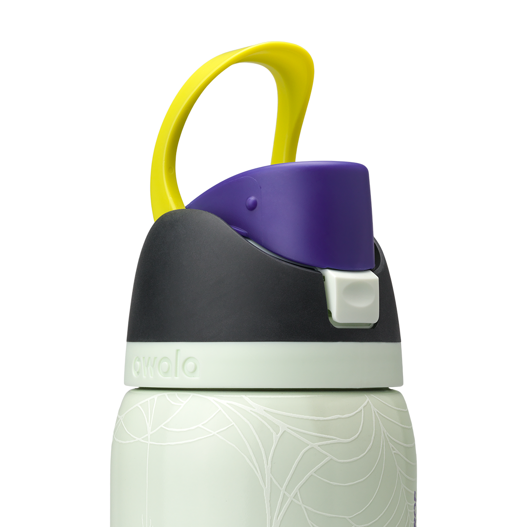 Owala FreeSip 32oz in RIP, close-up of black lid with pale mint accent band, purple flip cap with pale mint push-button and yellow carry loop standing up