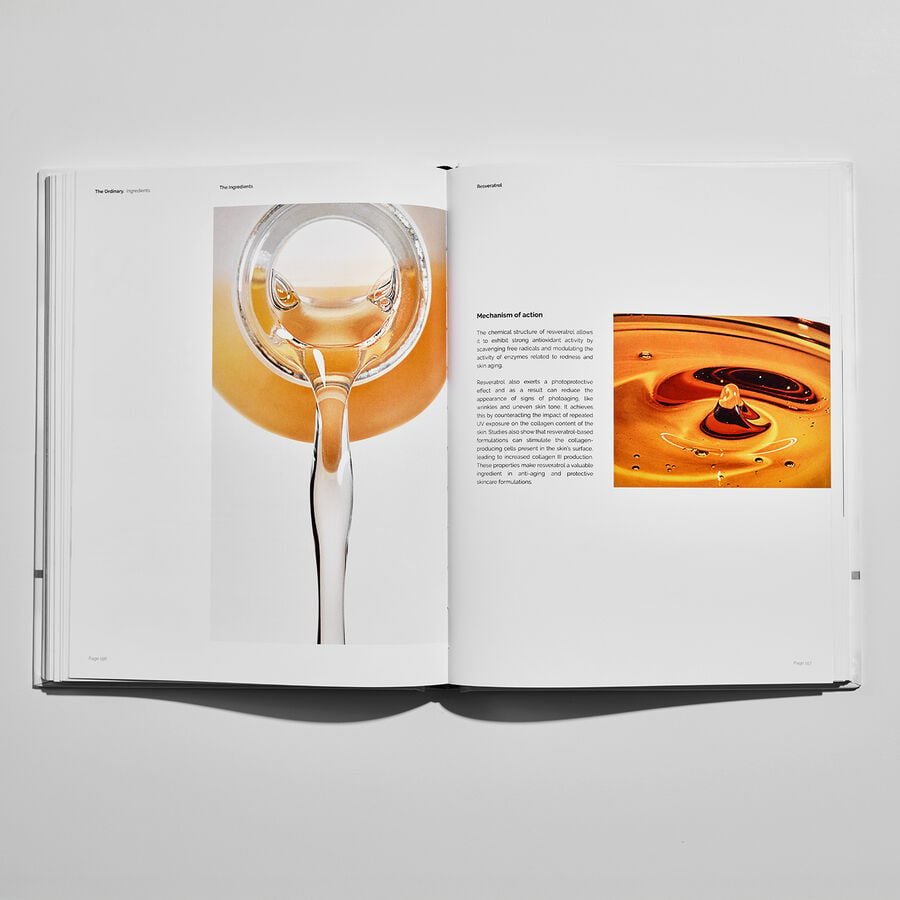 Flatlay of The Ordinary Ingredients hardcover book open to display the Mechanism of Action for Resveratrol 